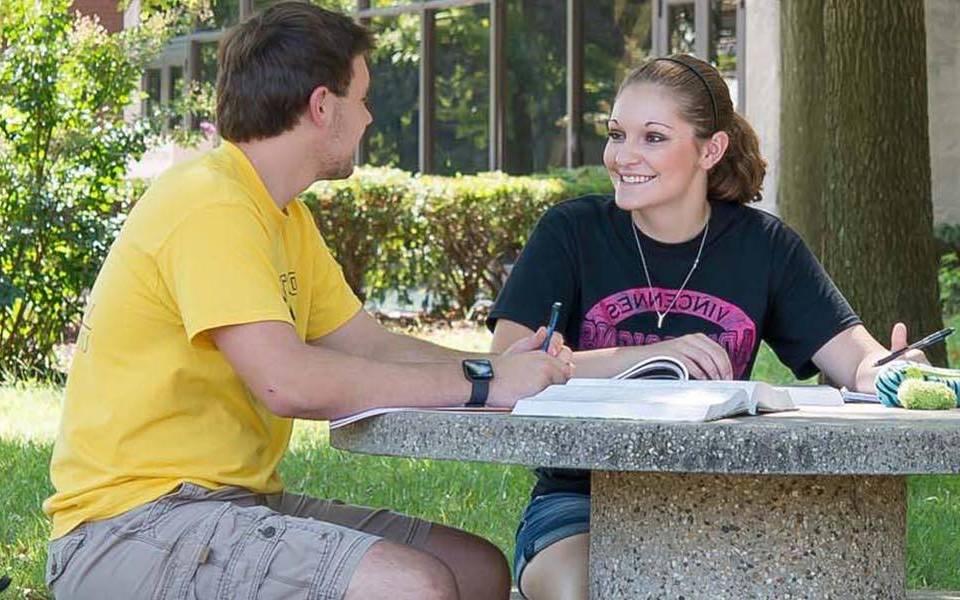 Female and Male student studying on Vincennes University campus